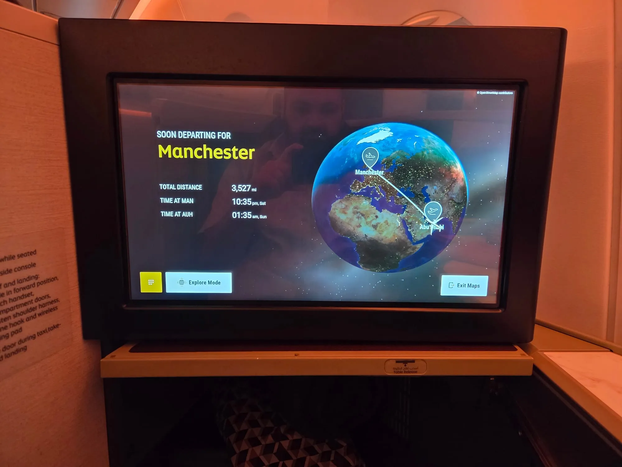 Seat-back screen showing the flight to Manchester about to depart