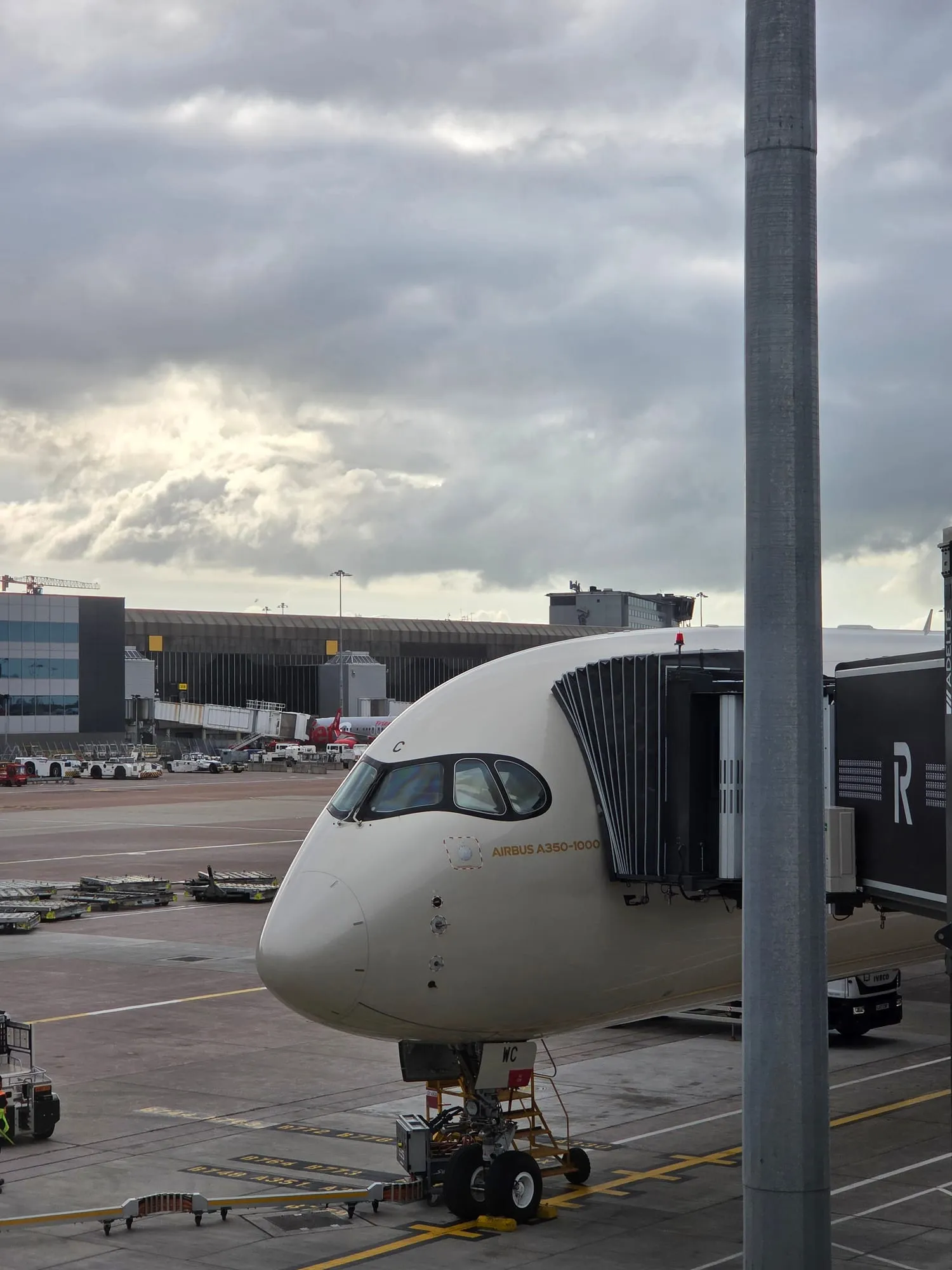 Aircraft nose at the gate, seen from the terminal window