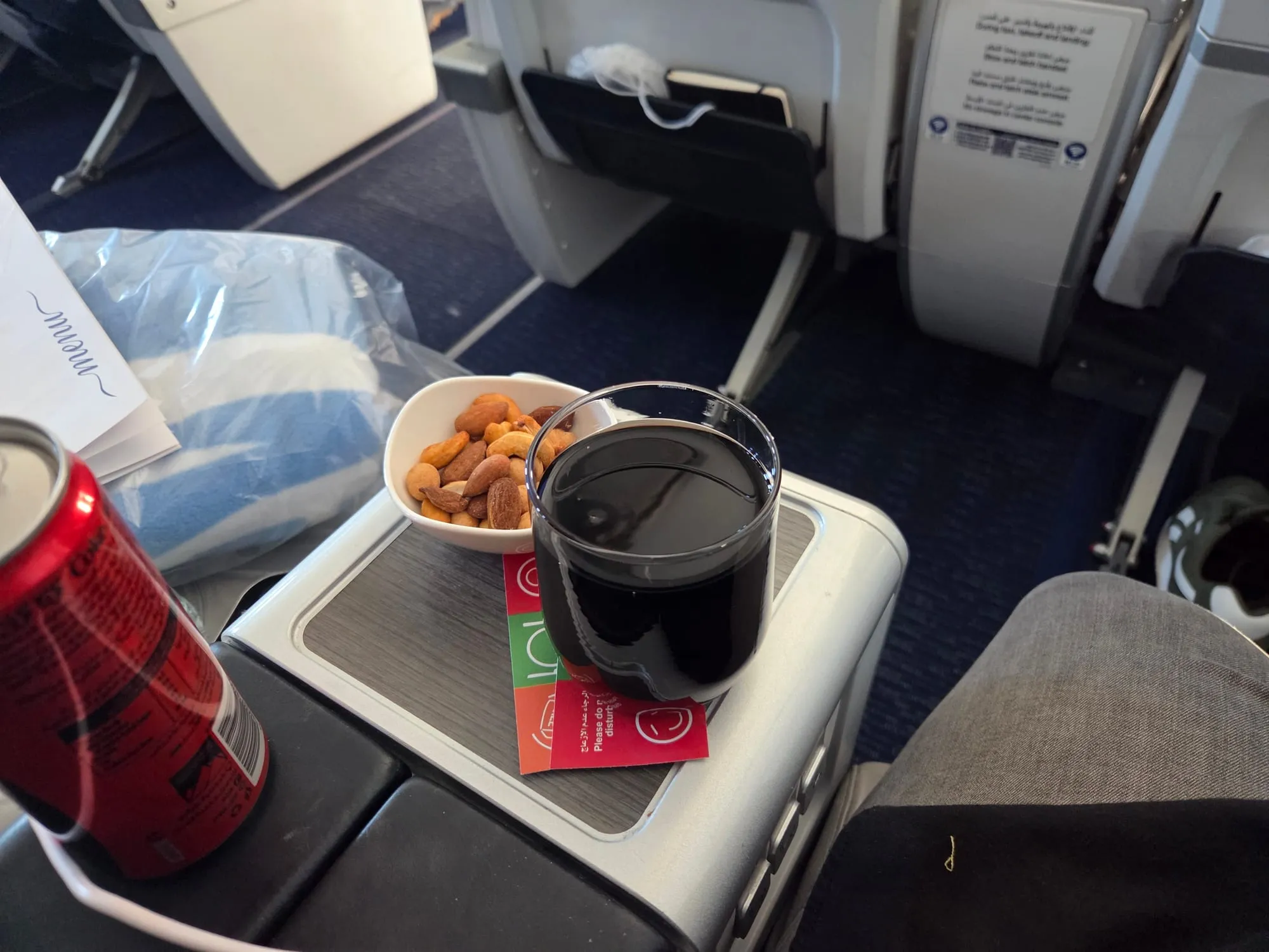 Drinks and warm nuts on the side table after take-off